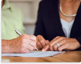  Lawyer and client reviewing and signing legal documents